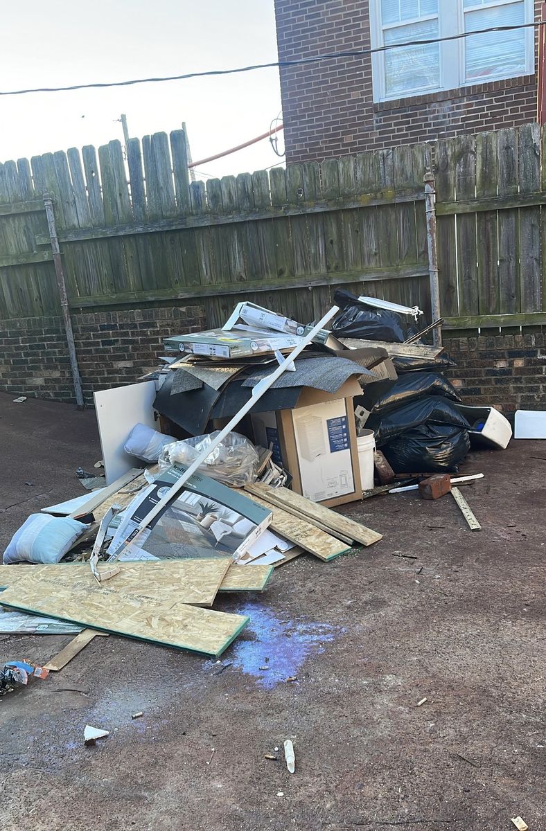 Backyard pile of boxes, bags, and debris